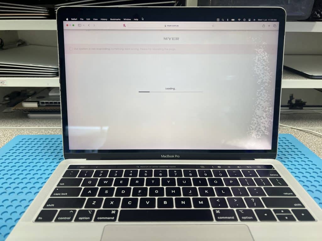 13-inch MacBook Pro A1989 working after 820-00850 water damage repair, with visible screen water marks from bottle leak inside a bag.